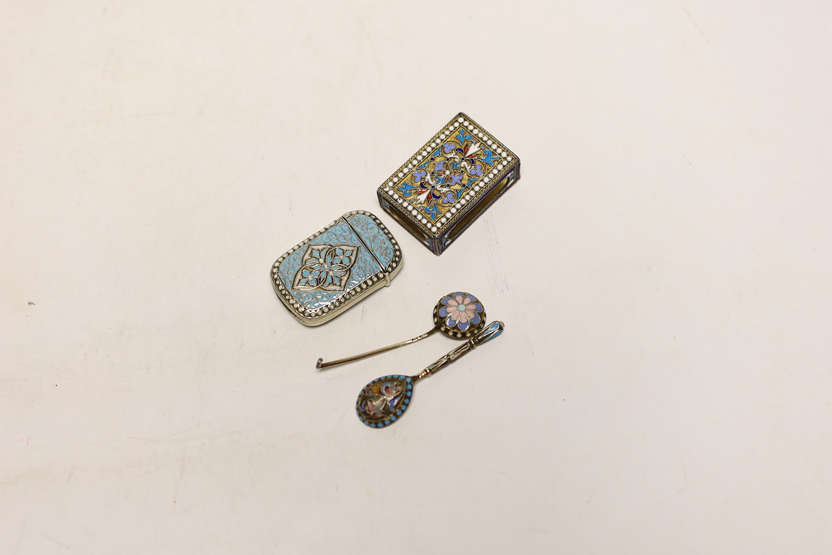 A 20th century Norwegian white metal and enamelled vesta case, by Marius Hammer, 47mm, together with two white metal and cloisonné enamel condiment spoons and a matchbox holder.